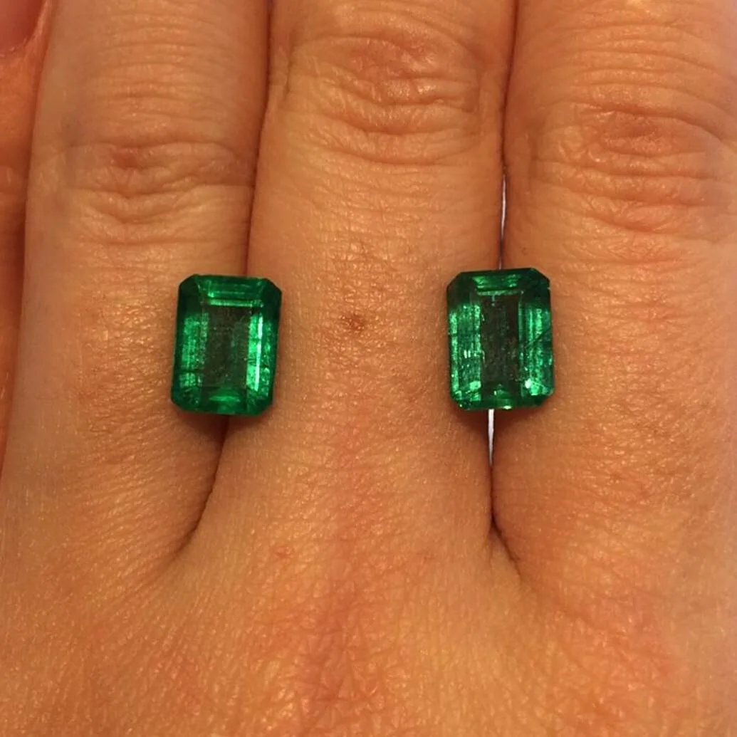 Cut emerald pair representing certification and document review